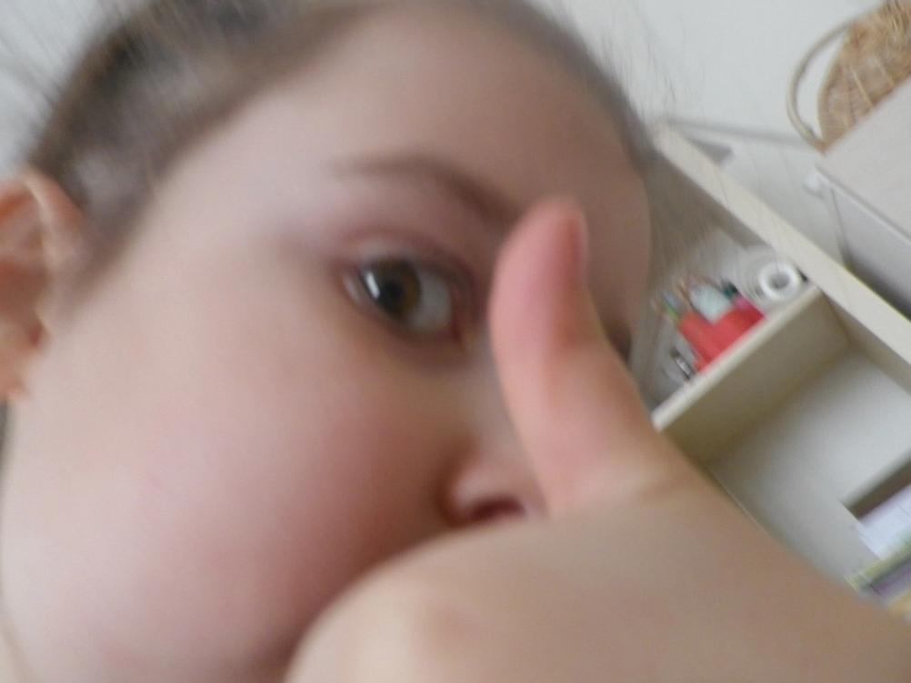 Selfie of my daughter giving thumbs up.