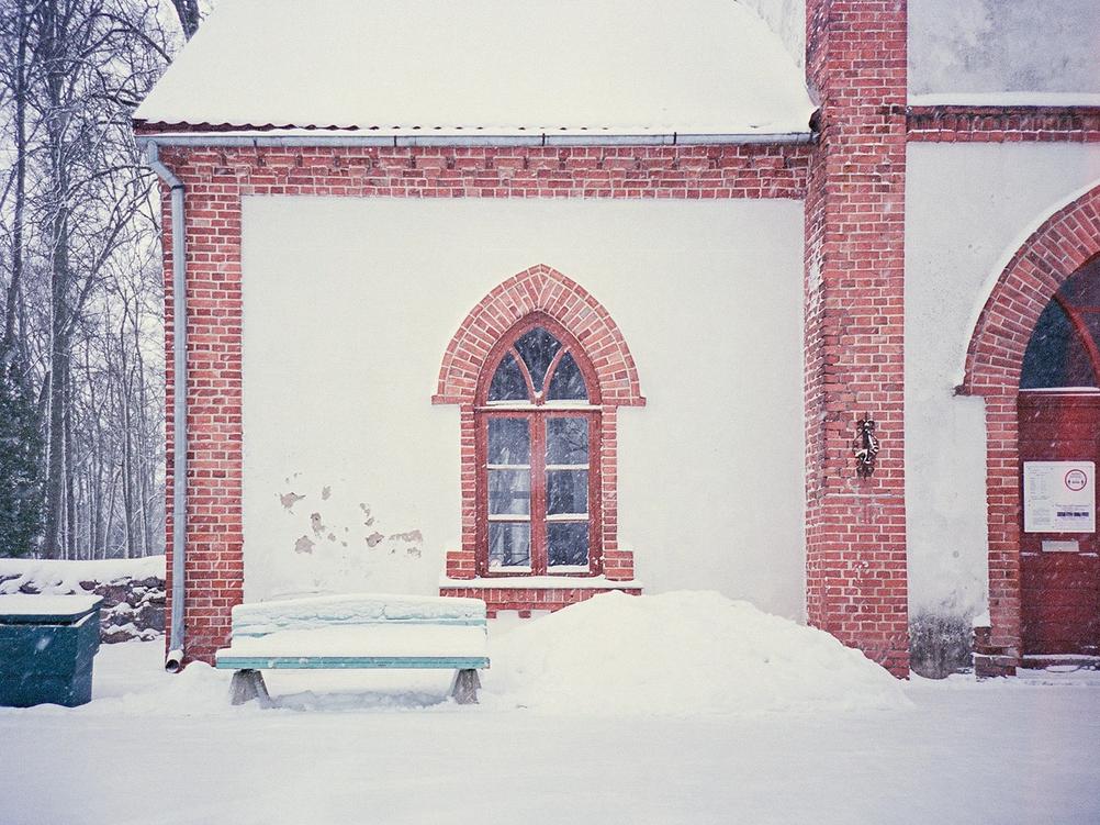 Photo of a bench in front of a church.