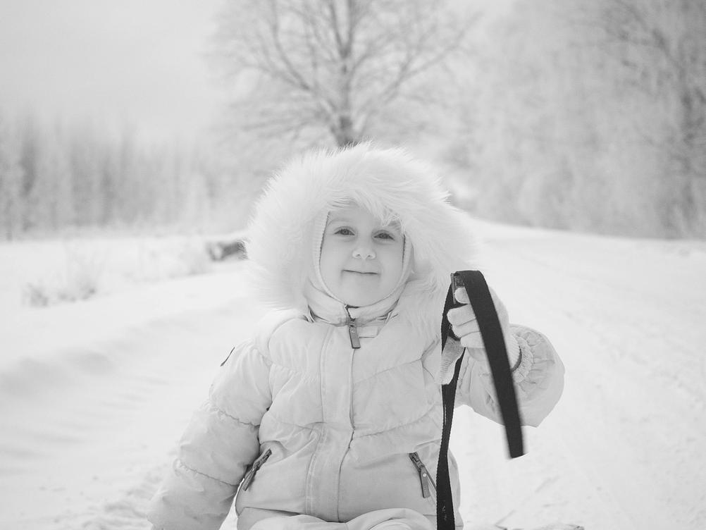 Photo of my daughter on a sled in the snow. Taken with an infrared camera.