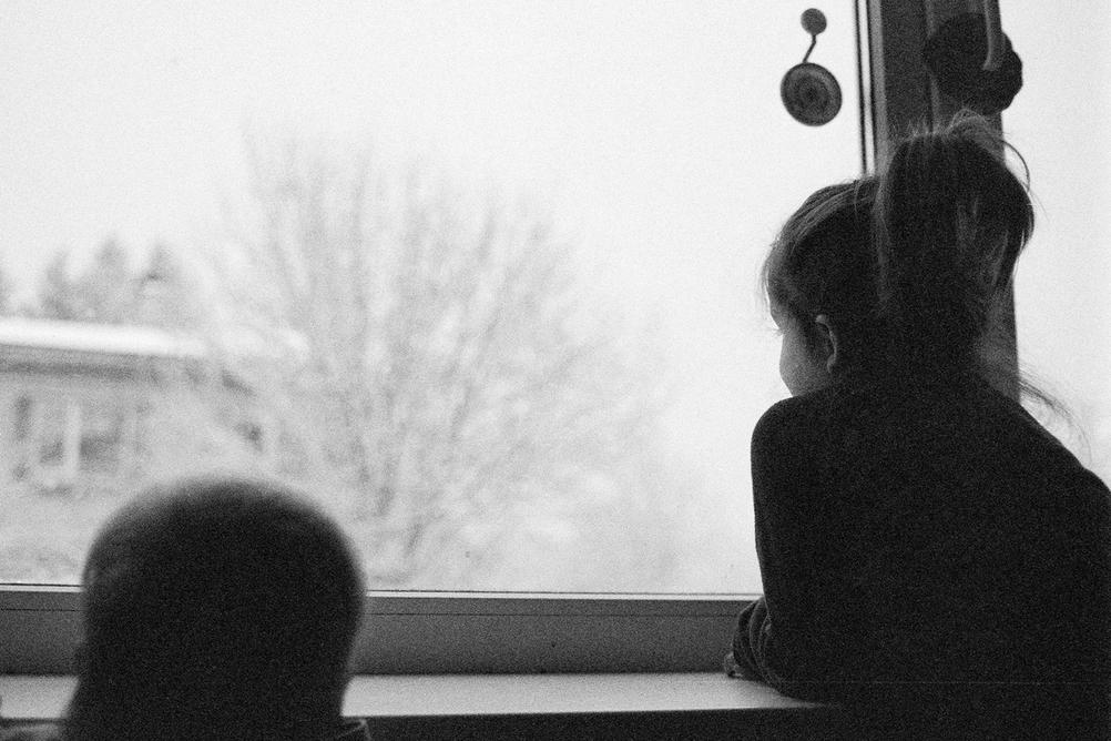 Photo of my children looking out the window.