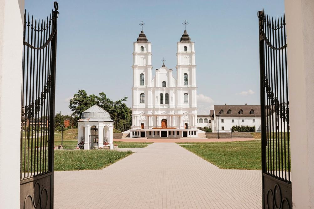 Photo of a church through open gate.