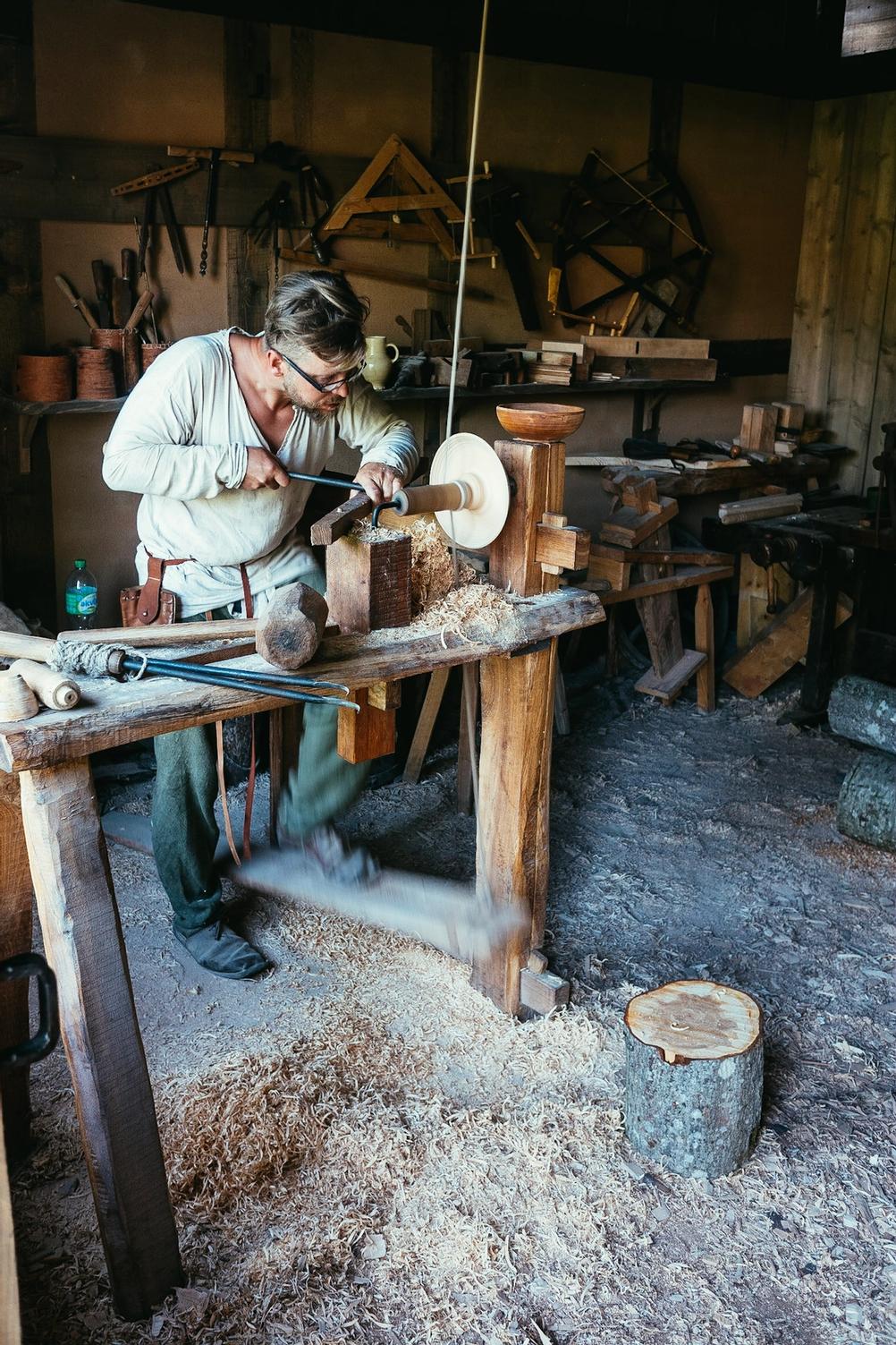 Photo of a man working dressed in historic clothes.