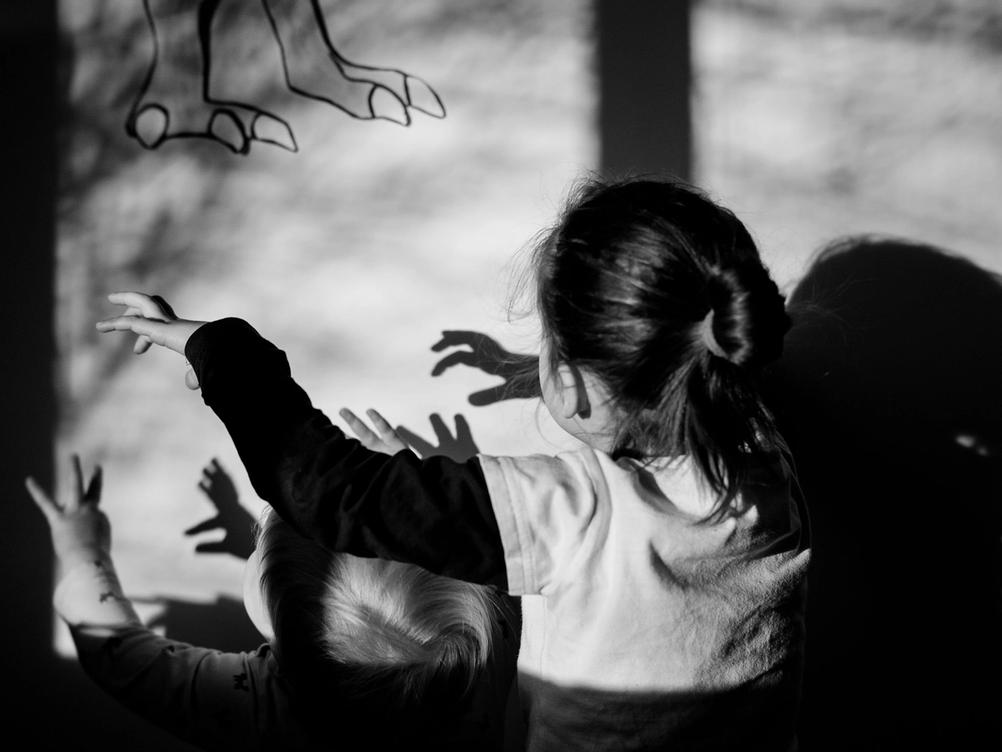 Photo of children acting like dinosaurs.