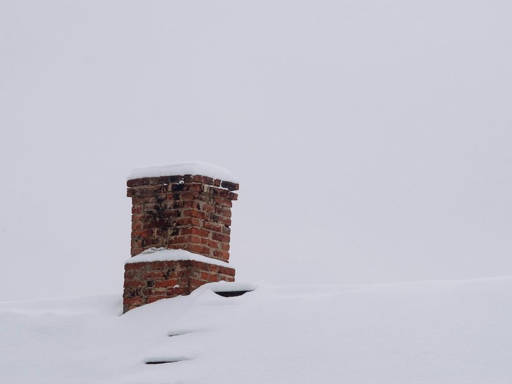 Photo of a chimney in the snow.