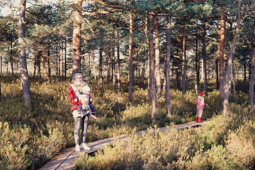 Mother and her children in forest.