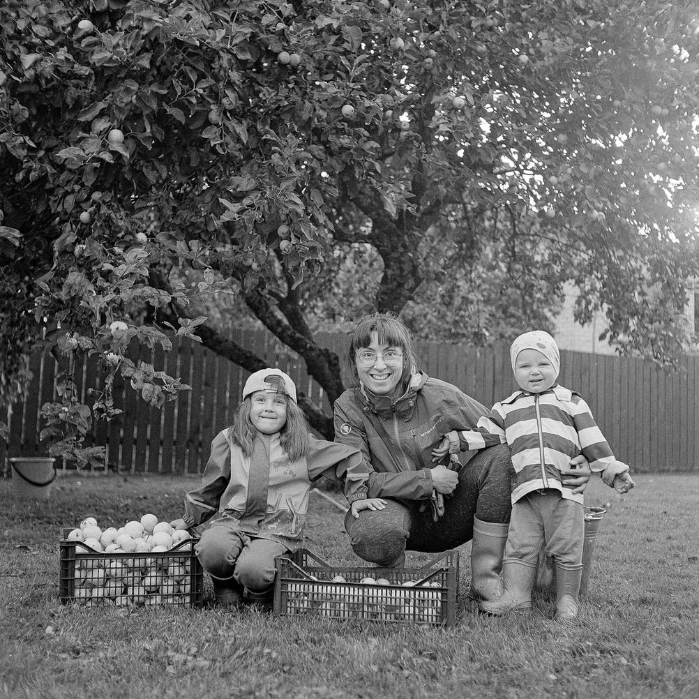 Photo of my family next to many apples.