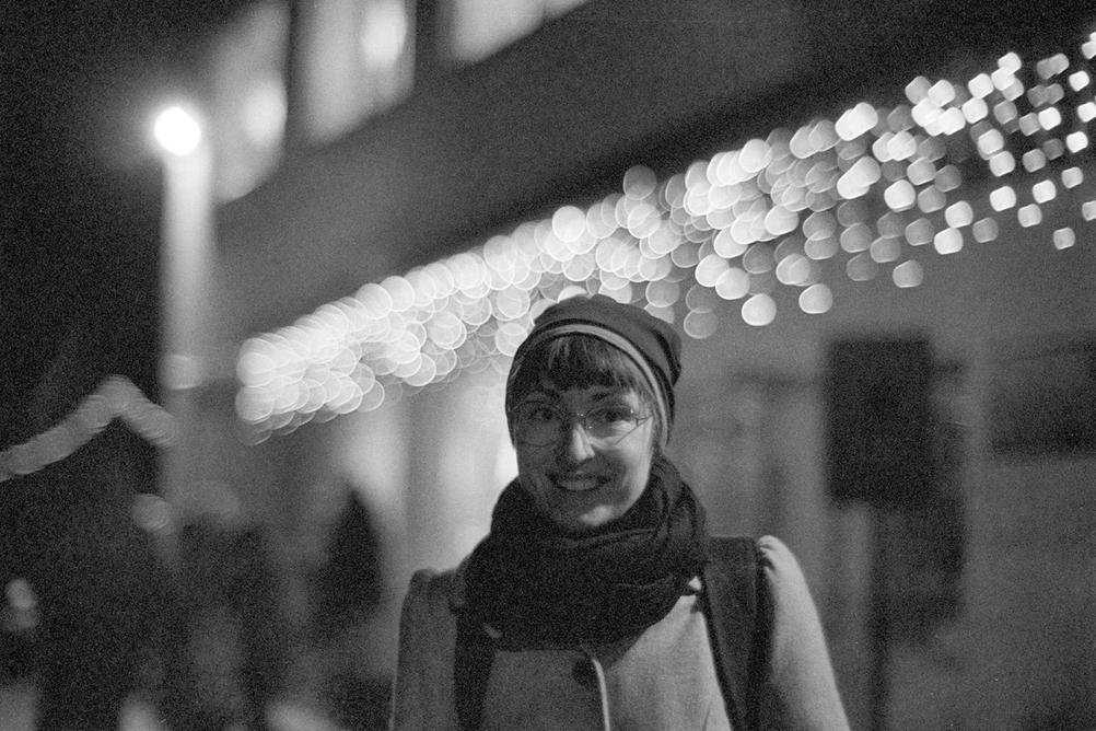 Photo of my wife with some lights in the background.