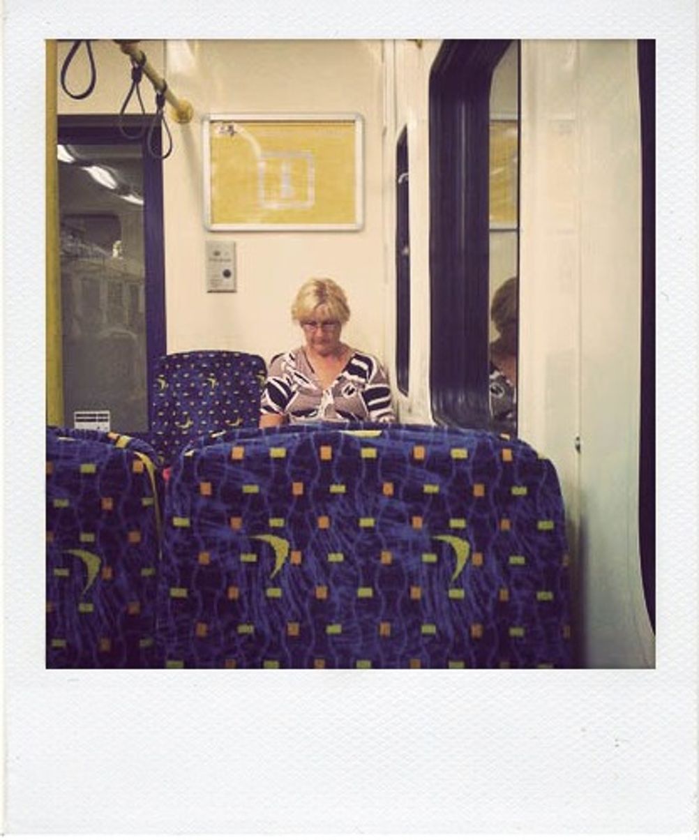 Photo of a woman sitting on a train.