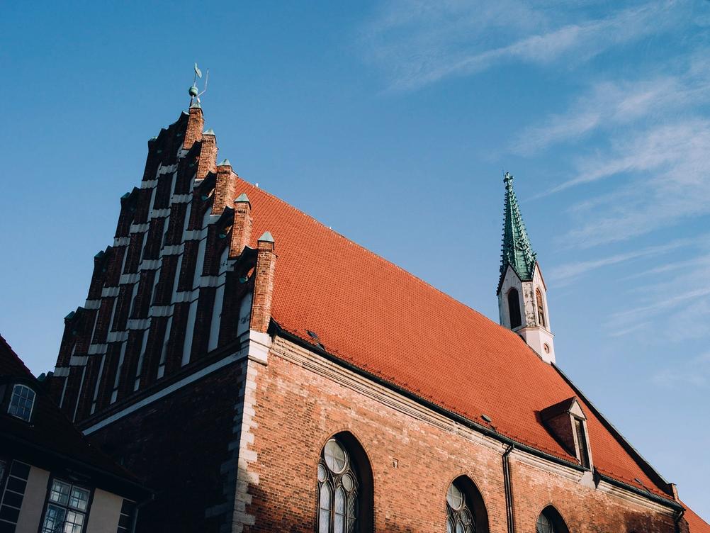 Photo of church roof being lit by sun.