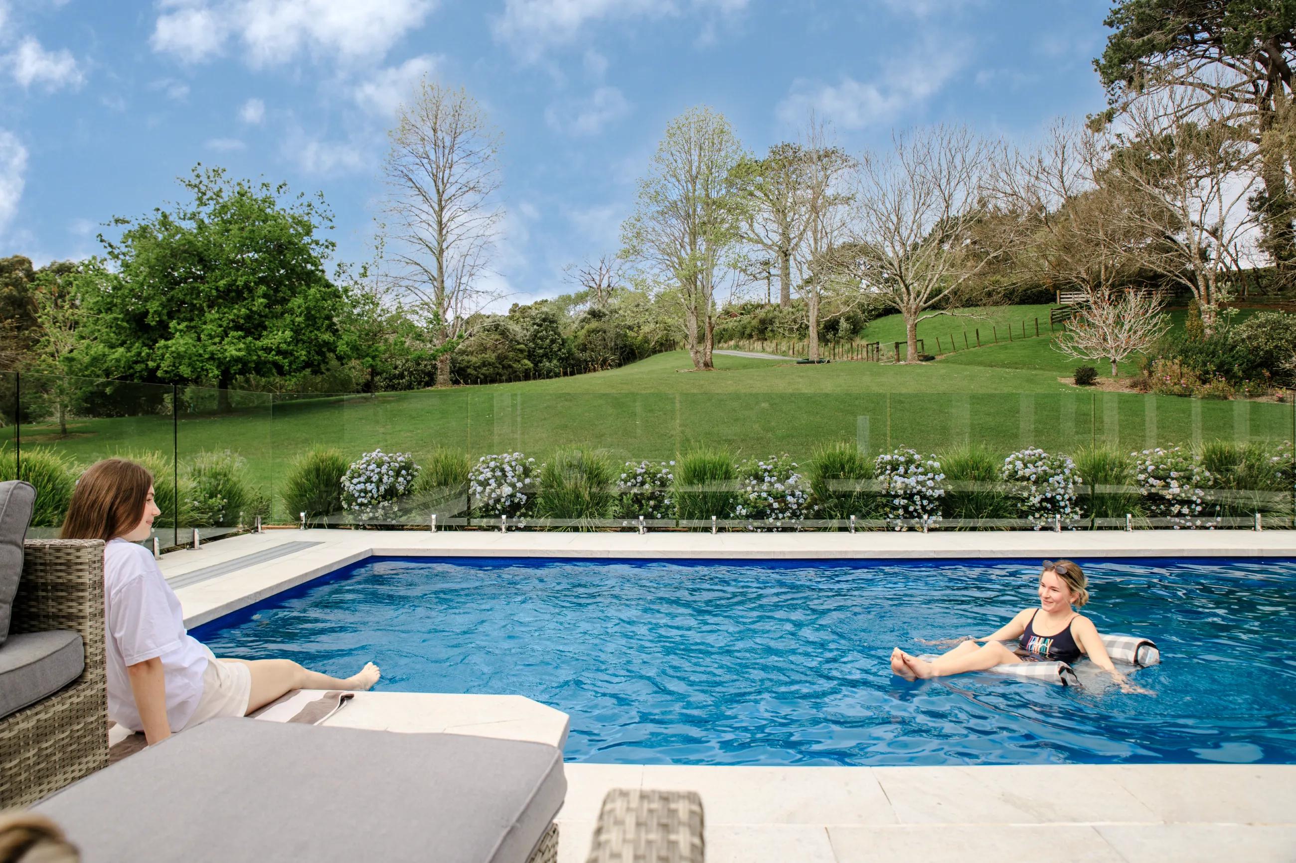 a swimming pool with blue tiles and stairs