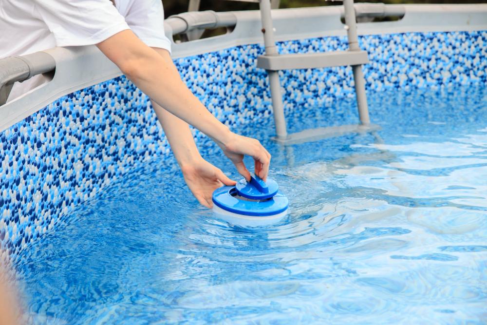 a swimming pool with blue tiles and stairs