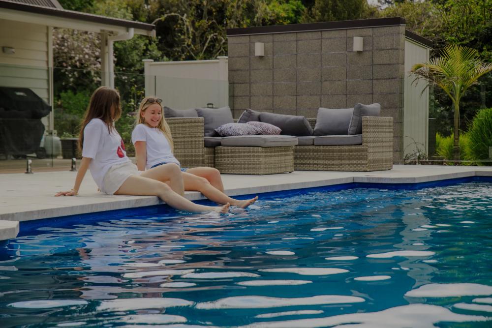a swimming pool with blue tiles and stairs
