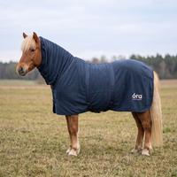 Óra Midnight Fleece-Abschwitzdecke mit Halsteil in Navyblau an einem hellen Isländer-Fuchs auf der Herbstweide, mit óra-Logo auf der Hinterhand