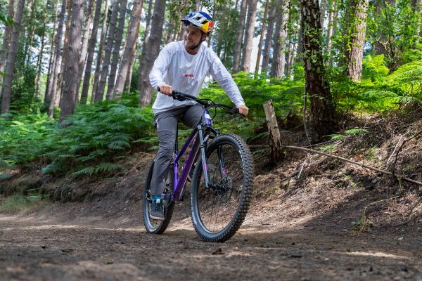 Rider on a Marin San Quentin hardtail on a wooded dirt trail