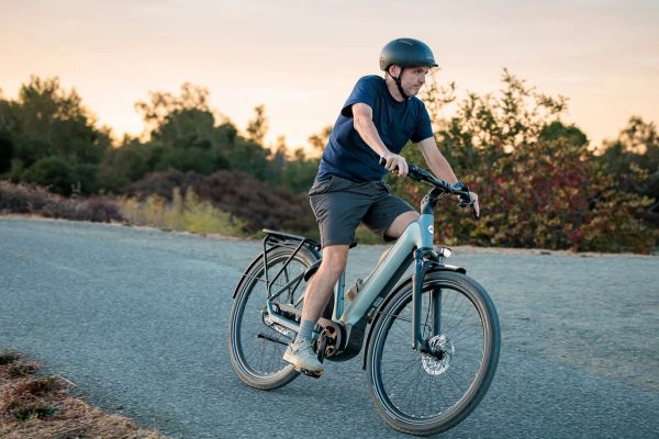 Rider on a Gazelle Ultimate e-bike on a road at sunset