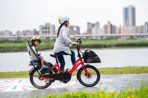 Parent riding a Tern NBD with a child in the rear seat