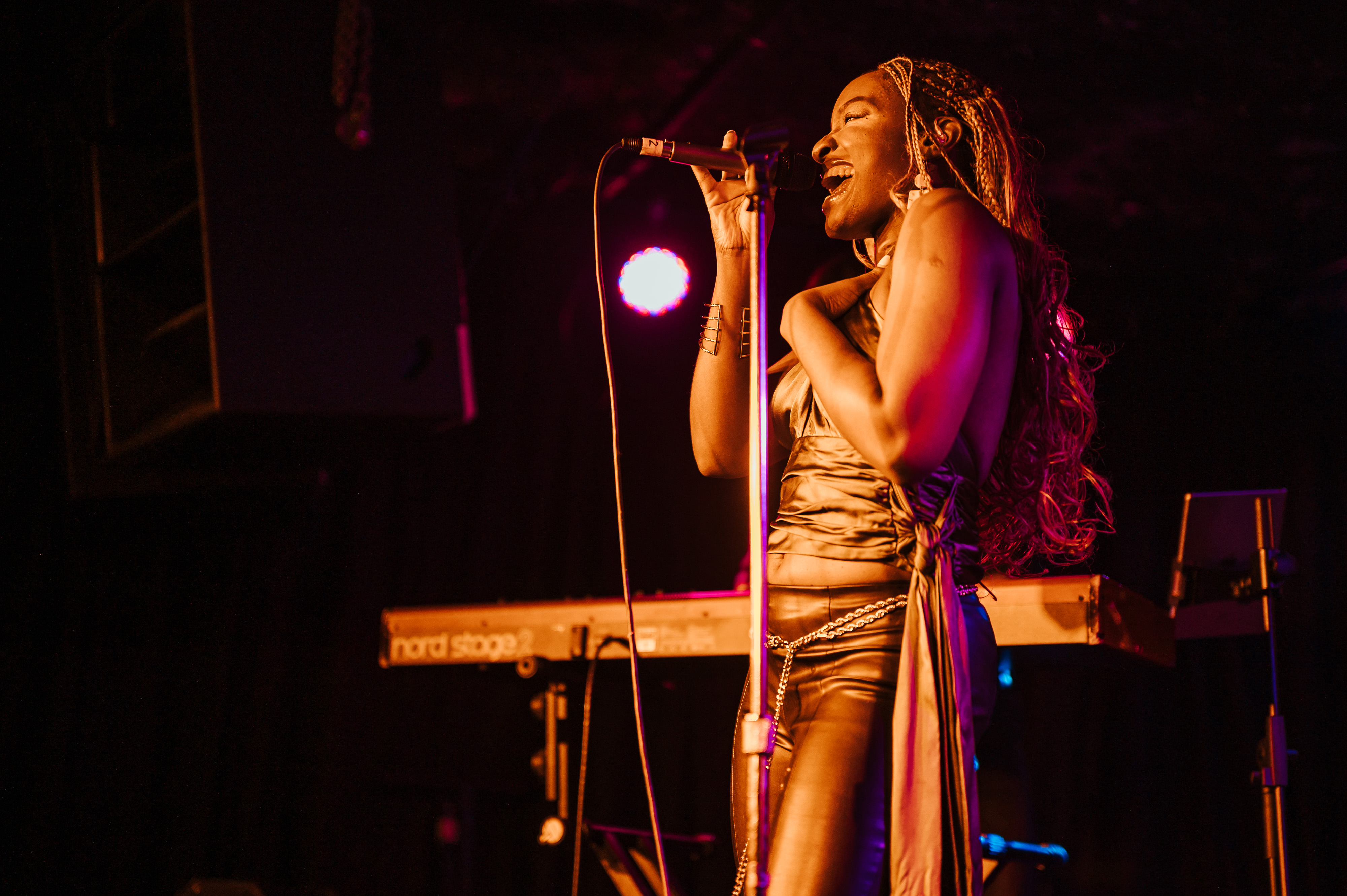 Sadé performing at ARC Showcase - golden lighting