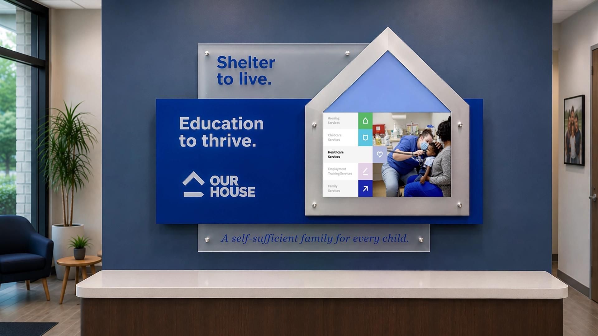 Custom digital donor recognition wall with layered acrylic panels, aluminum frame house-shaped digital display in nonprofit lobby.