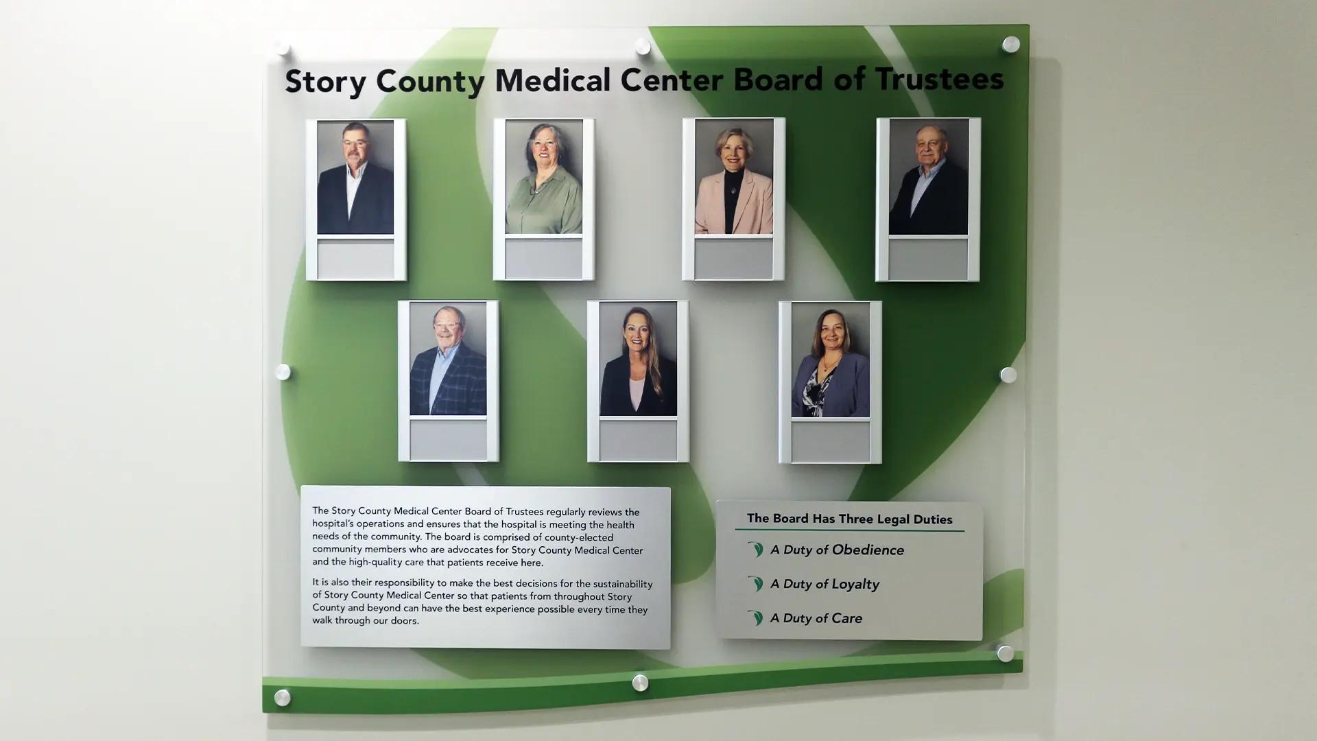 Medical center board of trustees wall with updateable portraits and logo-printed background at Story County Medical Center.