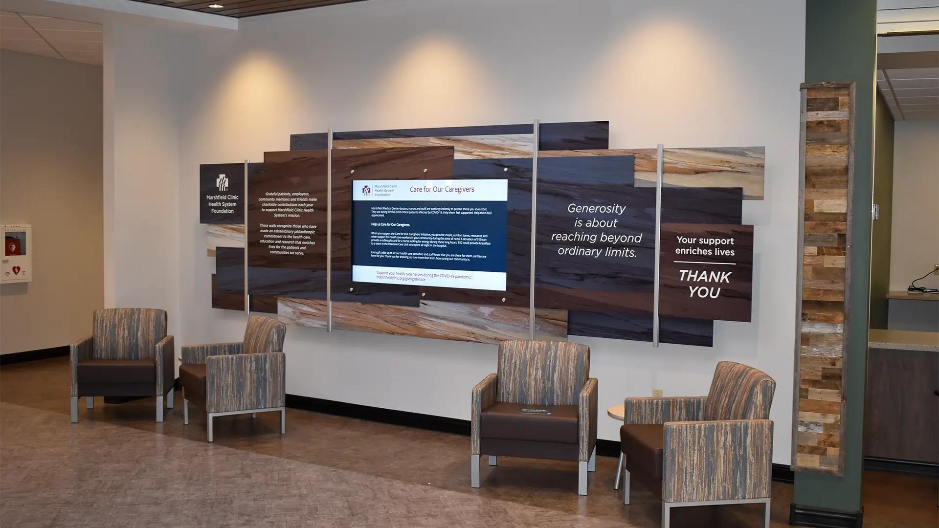 Marshfield Clinic Health System Foundation donor wall built with the Rail Wall System featuring wood-look panels and integrated digital display.
