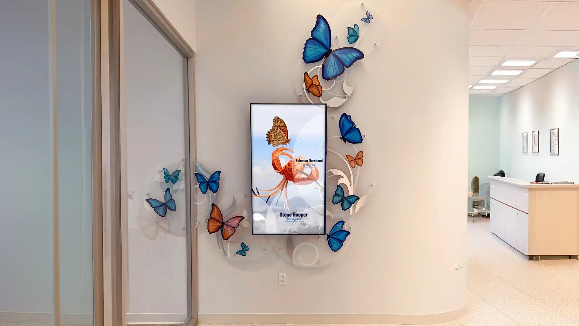 Digital recognition donor wall with LED display framed by dimensional acrylic butterflies, honoring organ donors in a vibrant, uplifting design.