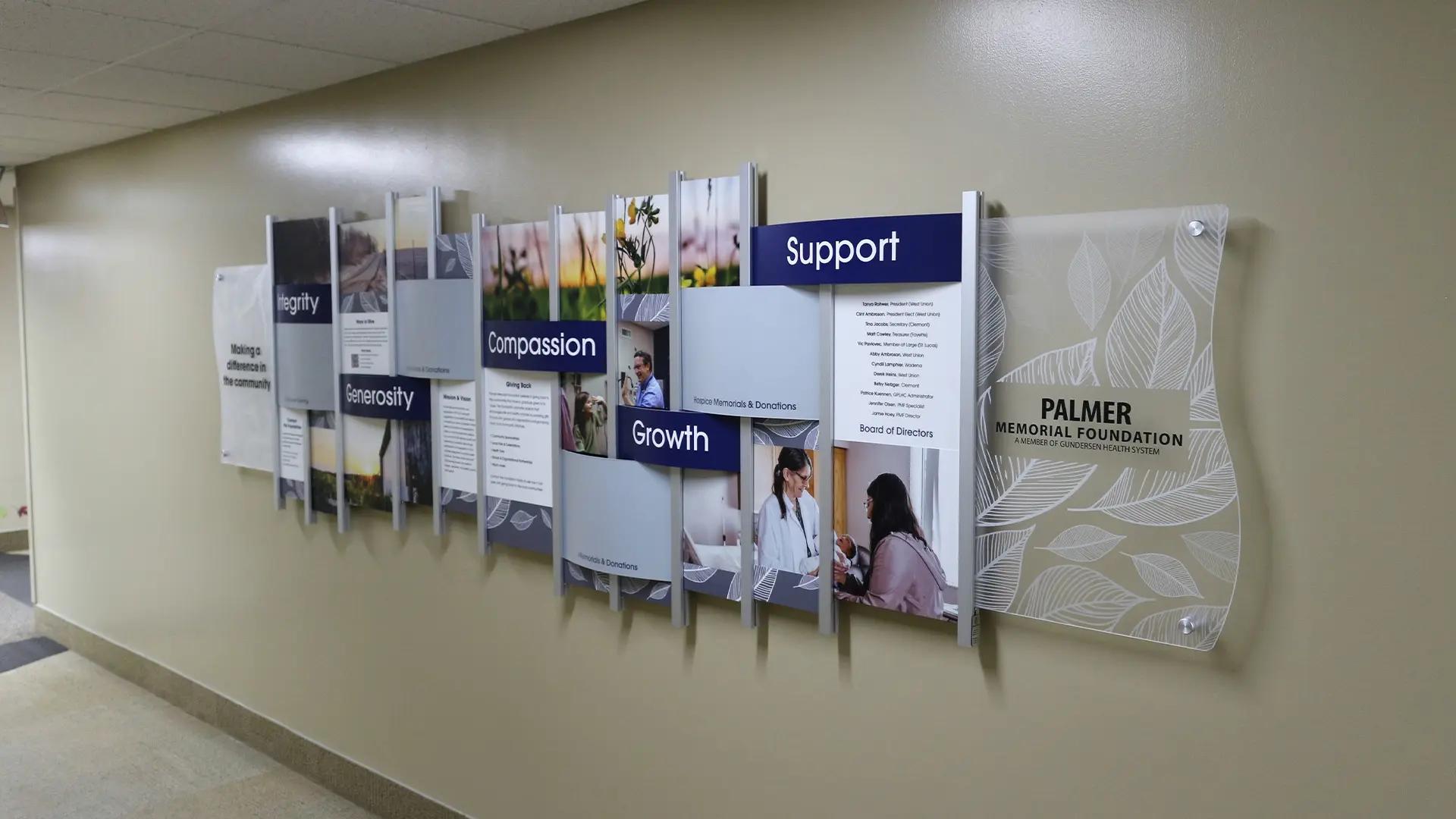 Palmer Memorial Foundation medical donor wall using the Rail Wall System with layered panels highlighting values, donors, and support services.