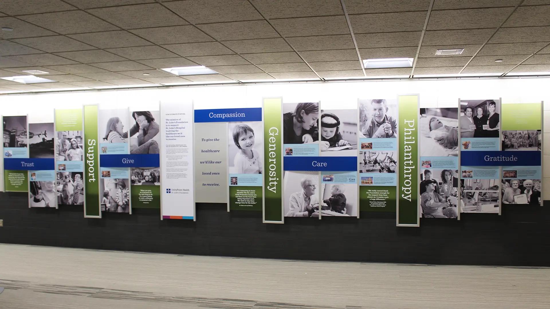 Large donor recognition and philanthropy wall with vertical panels highlighting compassion, generosity, care, and gratitude.