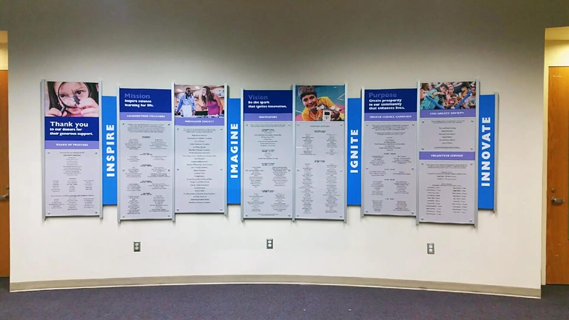 Orlando Science Center museum donor wall built with the Rail Wall System with mission panels, donor recognition, and bold inspirational messaging.