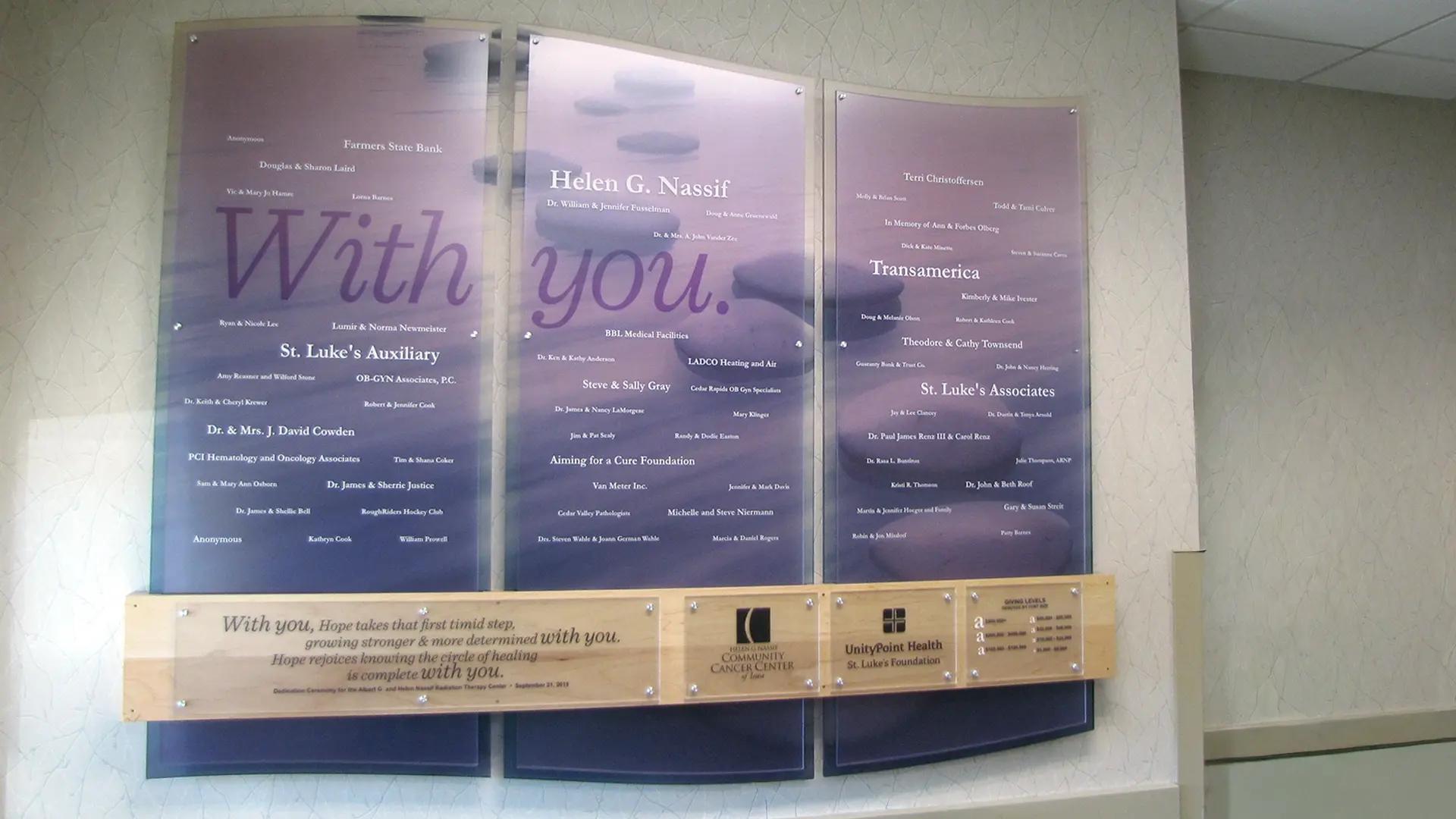 UnityPoint Health Nassif Cancer Center donor wall with curved translucent panels, printed donor names, and inspirational messaging.