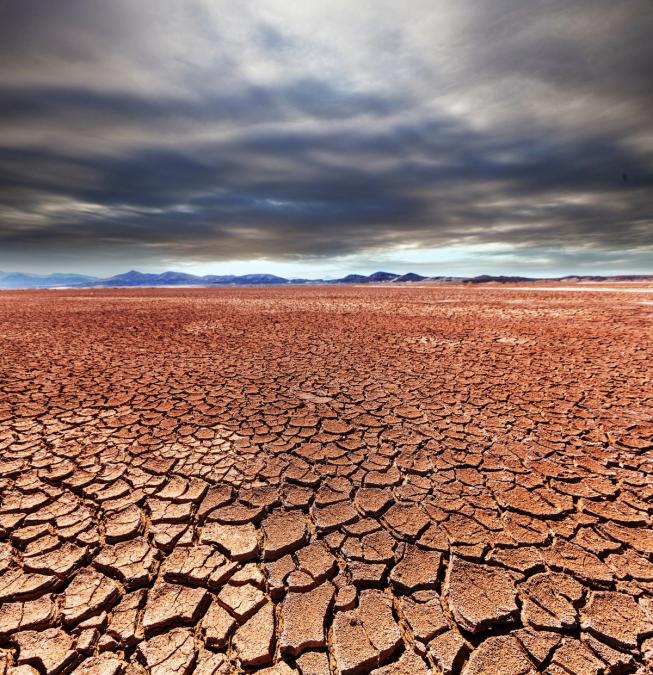 Cracked, dry ground under a heavy sky