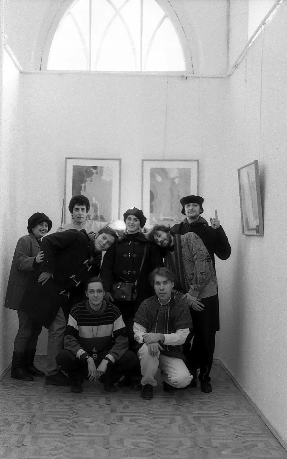 Participants of the exhibition against the backdrop of the works of Vasily Ryabchenko "Scary Love", 1994