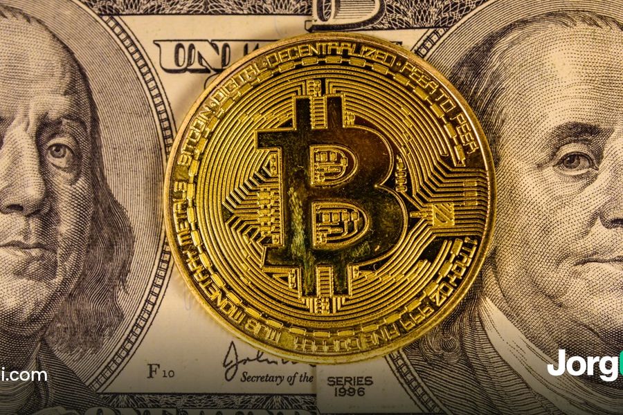 A Bitcoin coin resting on US hundred-dollar bills, cover for the study of Bitcoin after every Fed decision since 2020