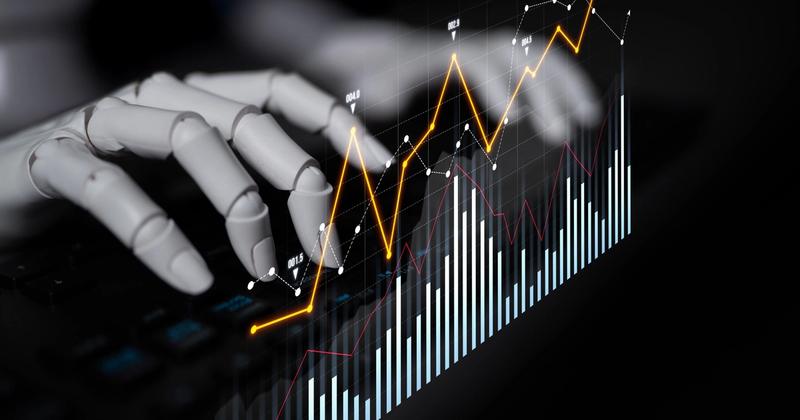 Robotic hand over a keyboard with a glowing line chart and bar graph overlay on a dark background