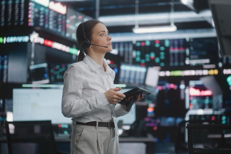 Analyst with a headset watching a wall of market screens ahead of the October 2026 Fed rate decision