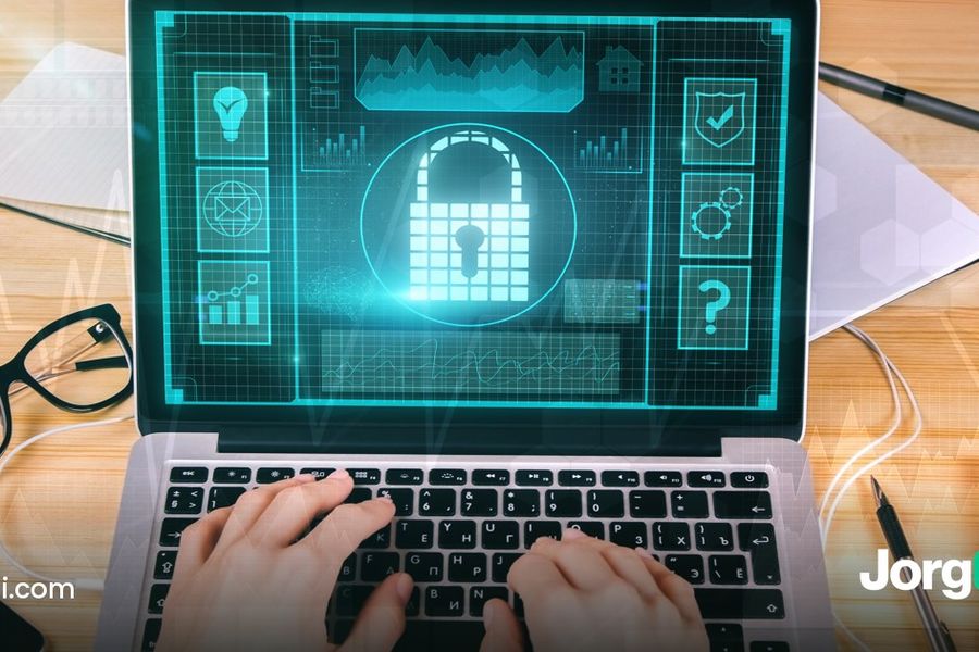 A hand on a laptop with a padlock resting on the desk, cover for the Kraken API key permissions guide for trading bots