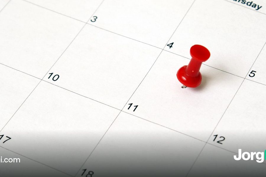 Red pushpin marking a date on a paper calendar, cover for the triple witching dates and data post