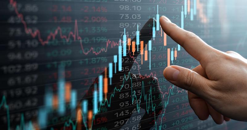 Finger tracing live market data on screen, representing the technical mechanics of the Schwab Trader API