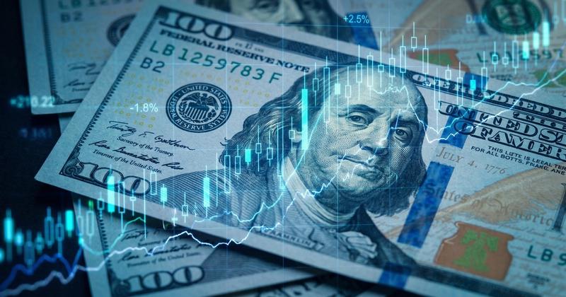 Hundred dollar bills overlaid with market price charts representing the Federal Reserve's September 2026 rate decision