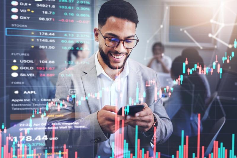 Trader smiling at phone with market charts overlay, representing API-friendly brokerage automation
