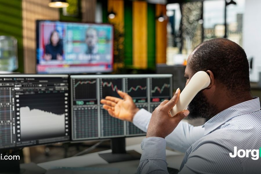 Trader at a bank of market screens, cover for the Kraken automation guide