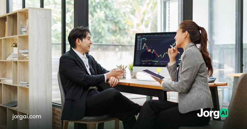 Two people reviewing figures at a meeting table, cover for the Oracle and CoreWeave AI debt selloff post
