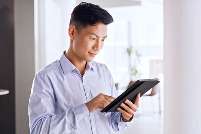 Calm investor reading a tablet in a bright office, illustrating how to trade stock market volatility without panic