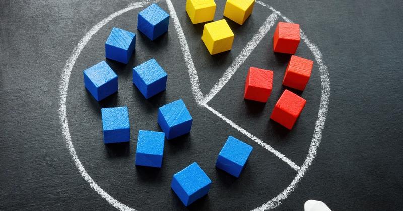 Colored building blocks arranged as a pie chart, representing diversification with ETFs versus individual stocks
