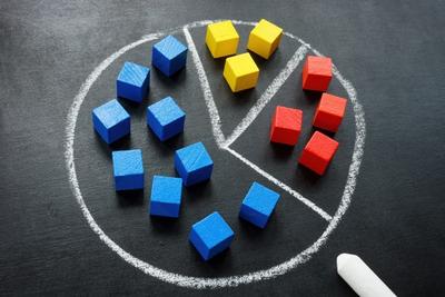 Colored building blocks arranged as a pie chart, representing diversification with ETFs versus individual stocks