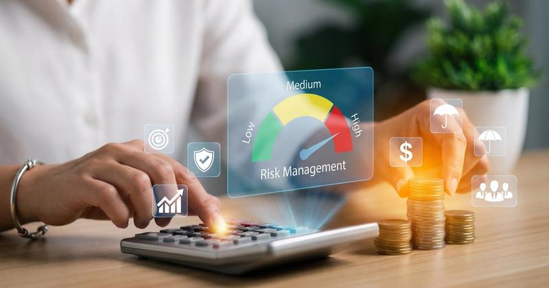 Hands adjusting a risk management dial beside a calculator, representing safe trading bot permissions