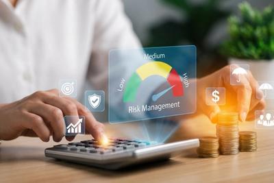 Hands adjusting a risk management dial beside a calculator, representing safe trading bot permissions