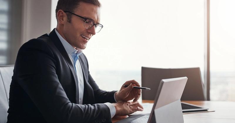 Investor reviewing his brokerage account on a tablet, representing automating a Charles Schwab account