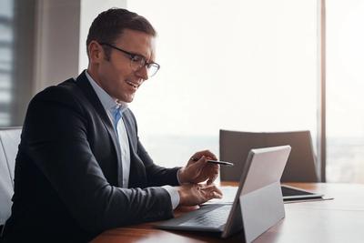 Investor reviewing his brokerage account on a tablet, representing automating a Charles Schwab account