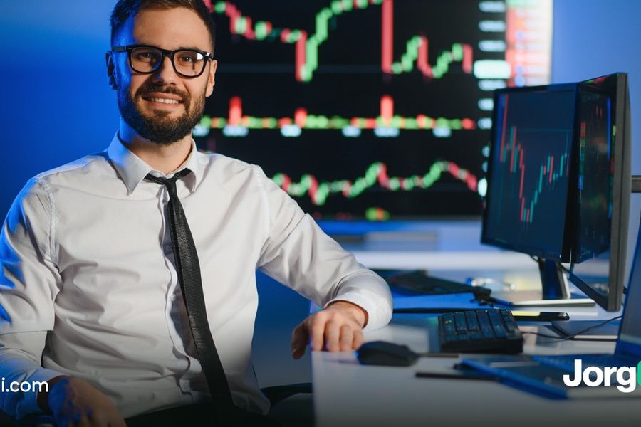 Trader at a desk with stock charts on two monitors, cover for the maximum drawdown guide