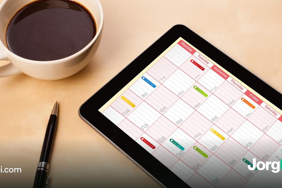 November 2026 stock market calendar: a tablet showing a monthly calendar next to a coffee cup and pen